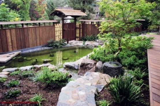 a Japanese garden with a pond, some shrubs and greenery and a couple of trees for a peaceful zen look