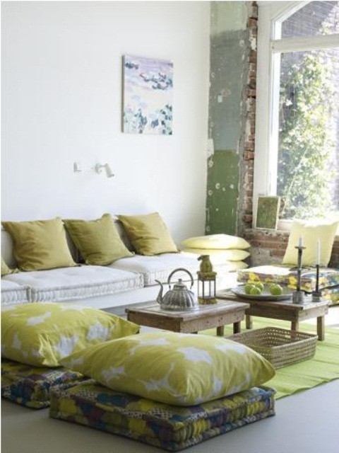 a neutral space done with mustard touches and low tables plus Moroccan tea pots