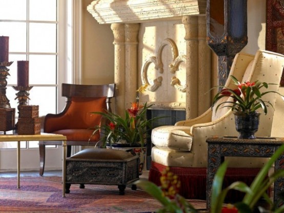 a neutral space with refined carved furniture and an ornate fireplace