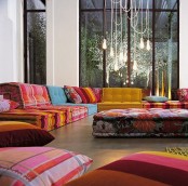 a colorful Moroccan living room with bold and patterned sofas and cushions plus pillows