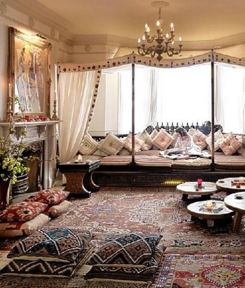 a welcoming Moroccan living room with lots of color and pattern, with low tables and pendant lamps