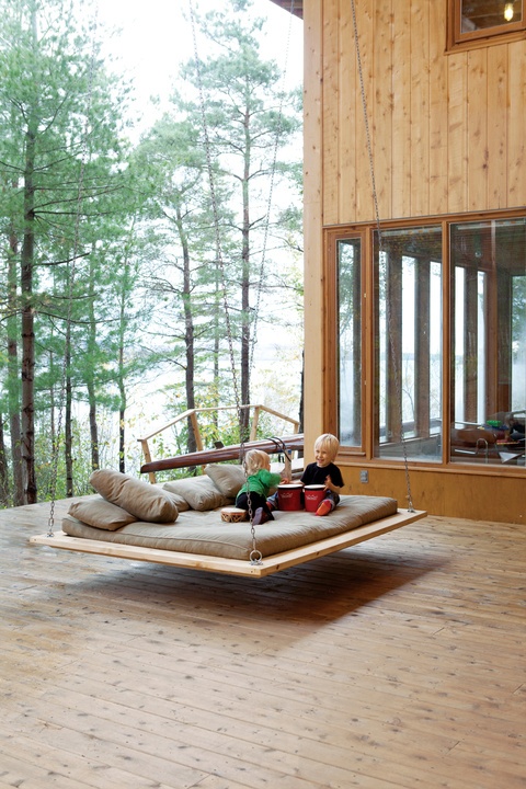a modern and sleek hanging bed on chains is a great place for your kids to play