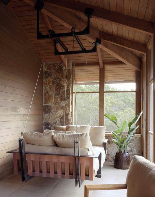 a wood and metal hanging daybed with lots of cushions and pillows is a gorgeous spot to get relaxed