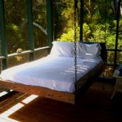 a simple anbd not very large daybed on chains inside a veranda or a sunroom is ideal to relax on it