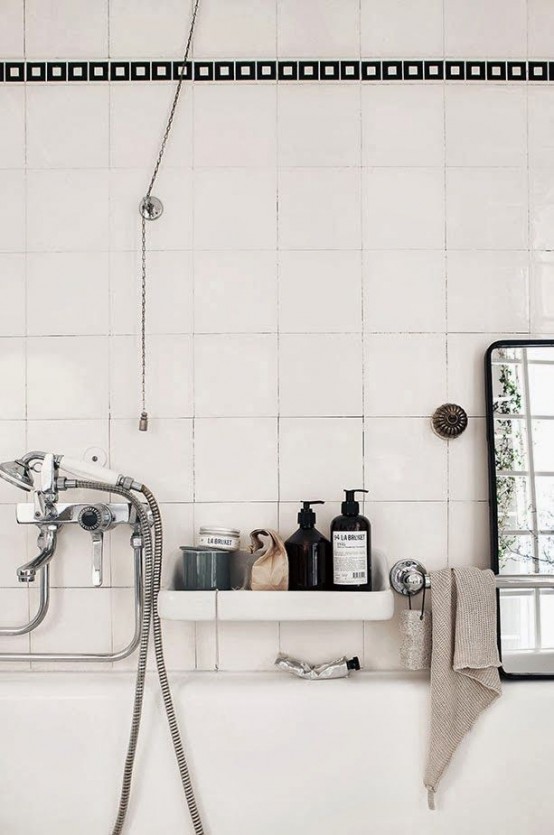 an off-white Scandinavian bathroom can be accented with black and vitnage appliances and faucets
