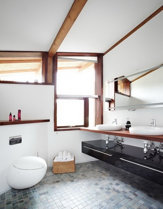 a cool contemporary bathroom with wooden beams, a black sleek vanity and a basket for storage