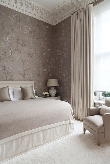a girlish and soft bedroom done in a neutral and pastel color palette, with mauve walls, neutral furniture, chic lamps and neutral textiles