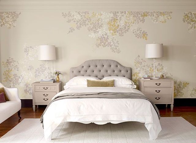 a neutral and cozy bedroom with a floral walls, refined vintage furniture, blush nightstands and table lamps