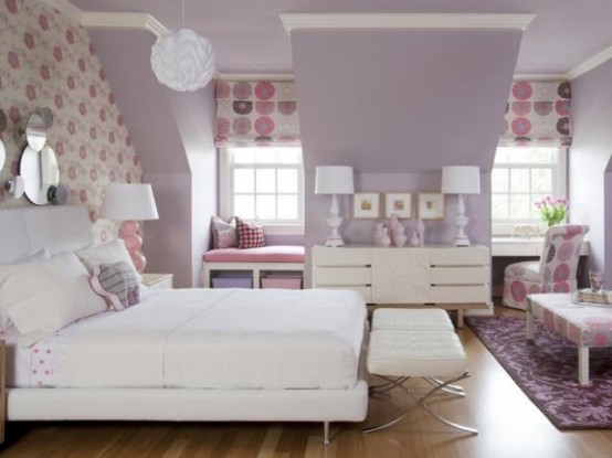 a lavender attic bedroom with an accent wallpaper wall, printed Roman shades, modern furniture and mirrors and artworks