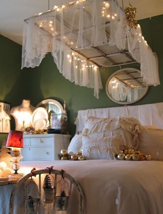 a framed window with a sheer curtain and lights hanging over the bed is a cool shabb chic idea