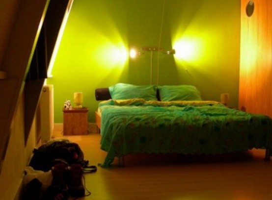 a creative wall lamp over the bed is a cool way to add light to the space