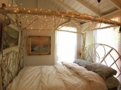 a branch frame with lights hanging over the bed for a relaxed and boho feel