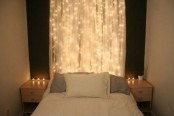 a real sheer curtain with lights instead of a usual headboard for a modern bedroom