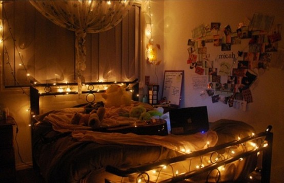 a headboard and a footboard covered with lights plus a large curtain lantern with lights