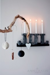 a branch with paper and fabric ornaments and cinnamon sticks is a minimalist and Scandi decoration for Christmas