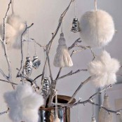 whitewashed branches with white and silver Christmas ornaments, fluffy and metallic ones