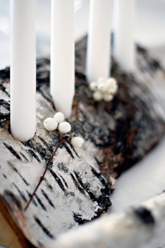 make a truly Nordic centerpiece of a tree stump with candles and berries to make the table look natural