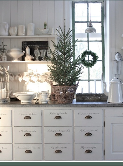 an evergreen Christmas wreath on the window and a Christmas tree in a basket for Nordic Christmas decor
