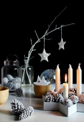 bleached pinecones, candles, whitewashed branches with metallic star ornaments