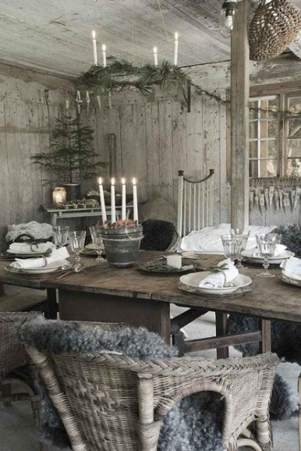 a Christmas tree in a pot, an evergreen chandelier with candles, faux fur for a Nordic and natural Christmas space