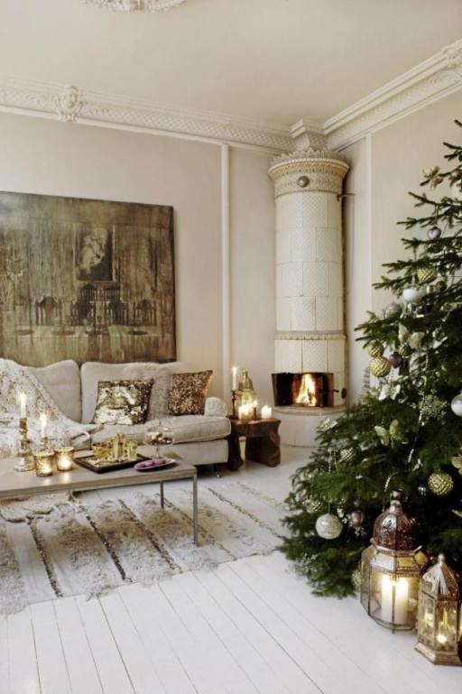a glam Scandinavian Christmas space with a tree decorated with metallic ornaments, candle lanterns, glam sequin pillows