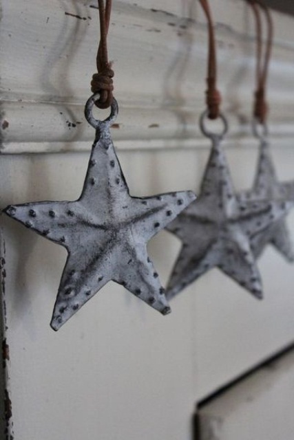 whitewashed metal stars with leather cord is a chic and cool idea for a Nordic Christmas