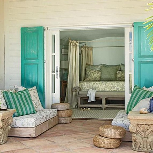 a neutral beach living space with bold turquoise touches and jute and rattan items