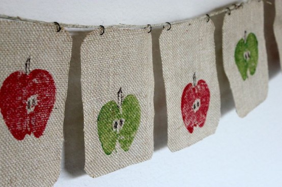a burlap banner with printed red and green apples is a cozy and unusual decor idea for the fall and Thanksgiving