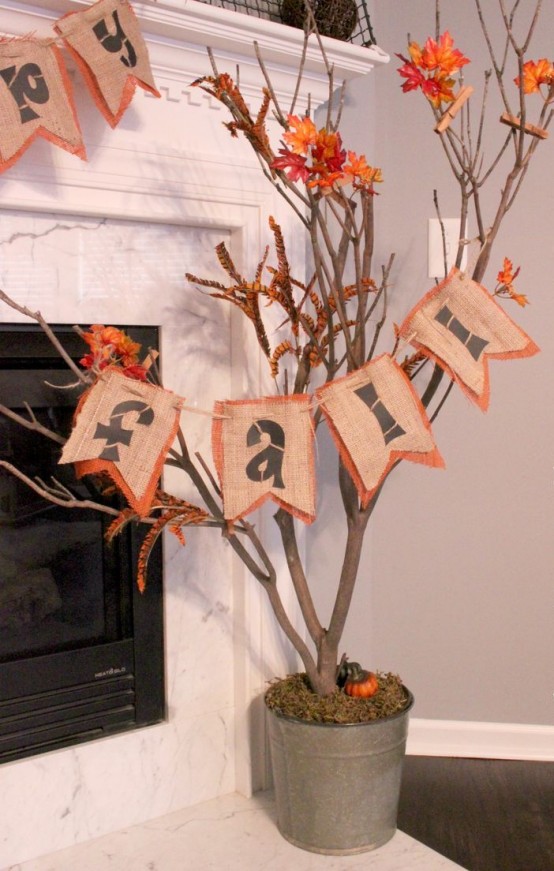 a neutral and orange burlap banner with painted letters is a cool and bold decor idea to rock in the fall and Thanksgiving