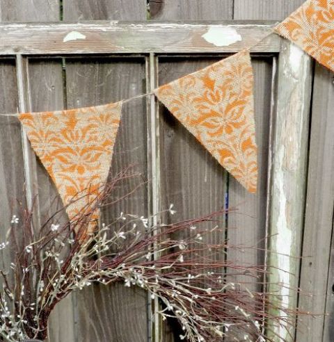 a pretty and cozy fall banner of burlap, with orange stenciling is a stylish fall or Thanksgiving decor idea to realize yourself
