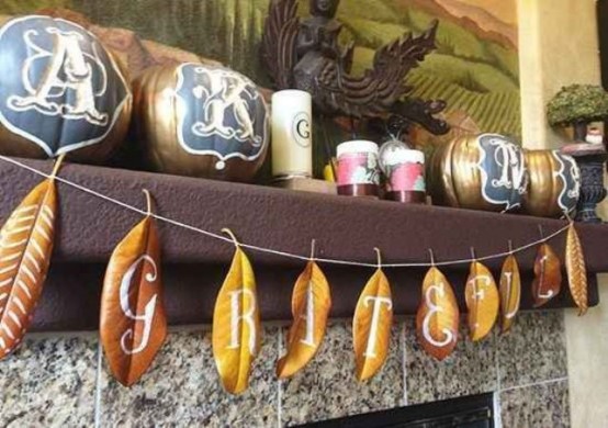 a creative fall banner made of leaves with white letters and patterns is a stylish idea that won't last long but it looks unusual