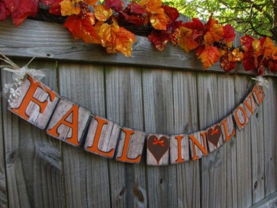a creative wooden banner with letters and hearts painted on the wood is a cool and chic fall and Thanksgiving decor idea with a rustic feel