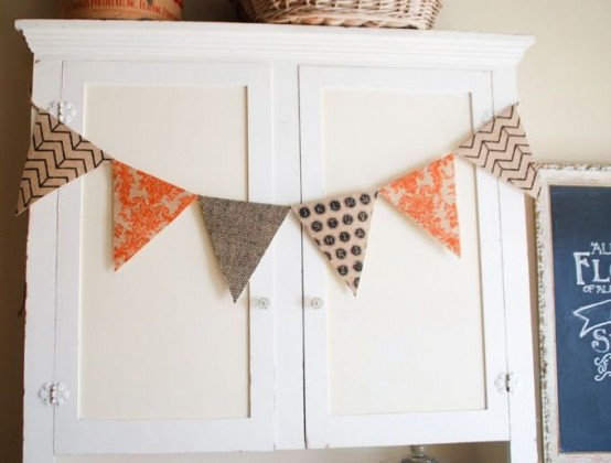 a neutral, orange and printed fabric banner is a stylish decor idea for the fall or Thanksgiving, and you can make one yourself easily