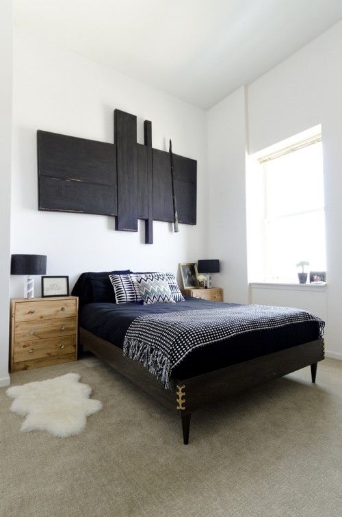 a black wooden mid-century modern bed and light-stained nightstands for a bold mid-century modern bedroom