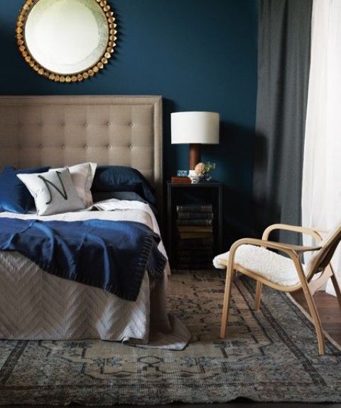 a neutral bed with an oversized upholstered tufted headboard and grey box nightstands for a bold and cool mid-century modern look