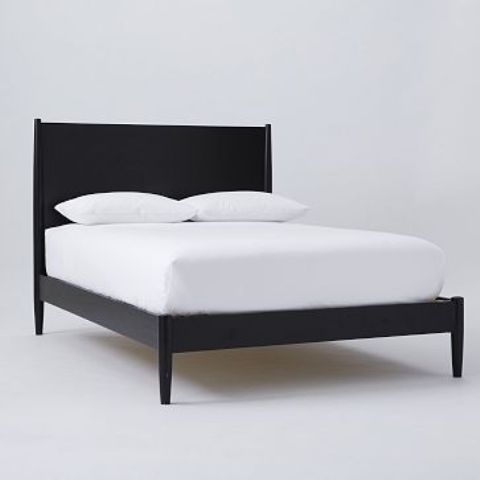 a very simple black mid-century modern bed with a laconic curved headboard is a stylish piece for a mid-century modern bedroom