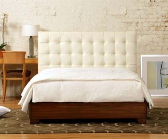 a rich stained wooden bed with a white leather tufted headboard looks chic and refined and will make a statement in a mid-century modern room