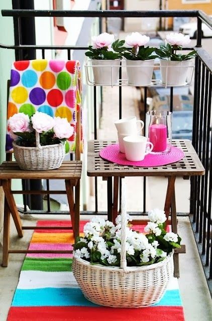 Brighten up your balcony colorful rugs and accessories like here - a bold rug, placemat and a pillow