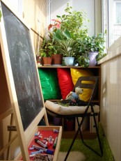 a small balcony with potted plants and a chair plus a kid’s easel to inspire your child to be creative