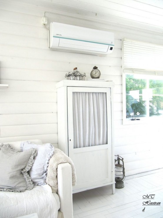 a stylish and small whitewashed cabinet with a glass door but with curtains is a cool idea for a Scandinavian interior