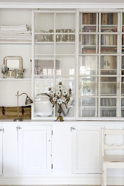 an oversized whitewashed storage cabinet with glass sliding doors and closed storage cabinet is a lovely idea for any space