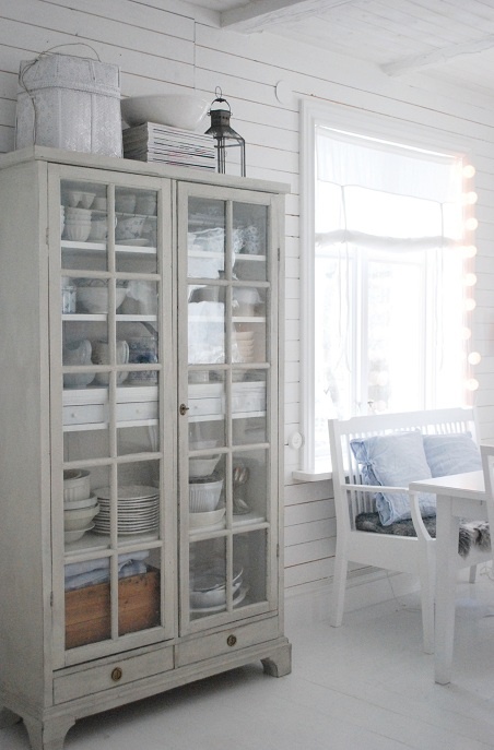 a pretty whitewashed glass cupboard like this one will give you storage and display at the same time and it looks very airy and lightweight