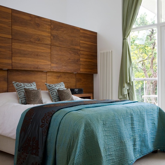 Who said that above bed storage should be ugly? Here is an awesome unit that blends with a headboard.