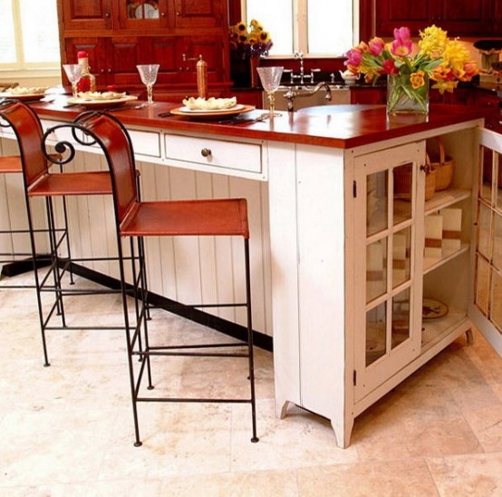 a farmhouse kitchen island with a storage space inside it and a butcherblock countertop is a stylish idea for a farmhouse space and your kitchen island works