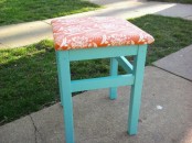 a turquoise IKEA Oddvar stool upholstered with bright coral printed fabric for a bold look