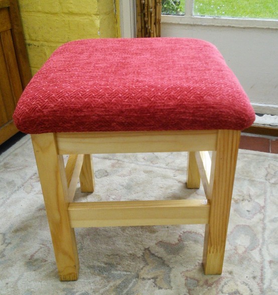 a neutral IKEA Oddvar stool refreshed with bright red upholstery for a touch of color in your space