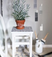 an IKEA Oddvar stool redone with grey tile shards on the seat may become a new plant stand in your home