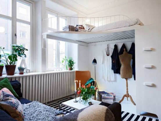a small bedroom upstairs, a platform with a bed over a tiny living room is ideal for small apartments