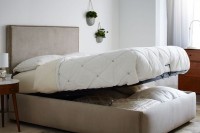 a neutral upholstered bed that can be raised to store some things inside it is an ultimate idea to rock