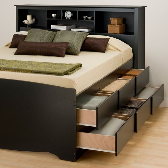 a functional black bed with a storage headboard and two levels of drawers in the sides is a cool solution to rock